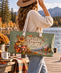 Fall Anyway sage green weekender bag with autumn botanical artwork carried by a woman in a cream sweater beside a scenic mountain lake.