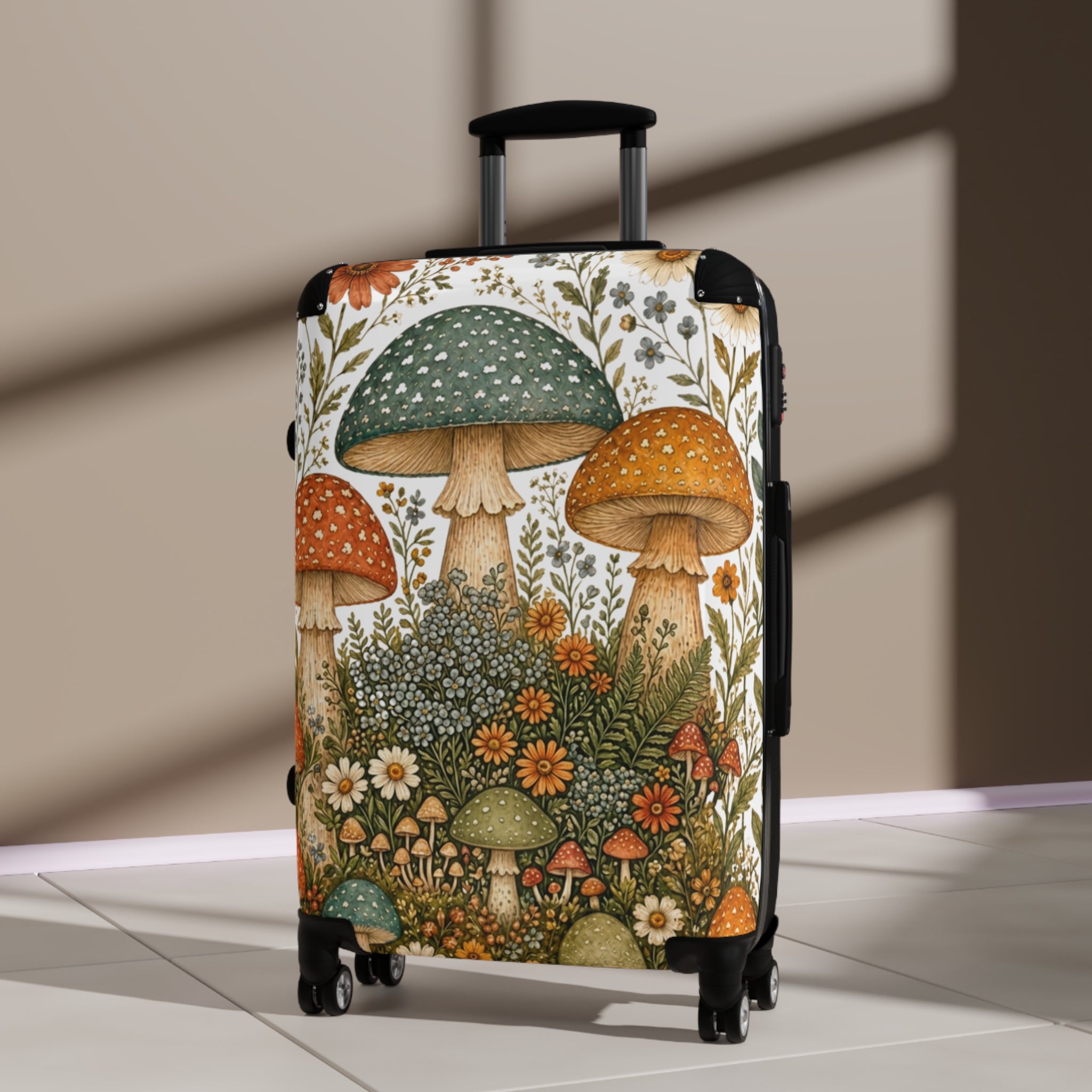 A hard-shell carry-on suitcase with an illustrated mushroom and wildflower print, standing upright on a light floor against a beige wall with soft window shadows.