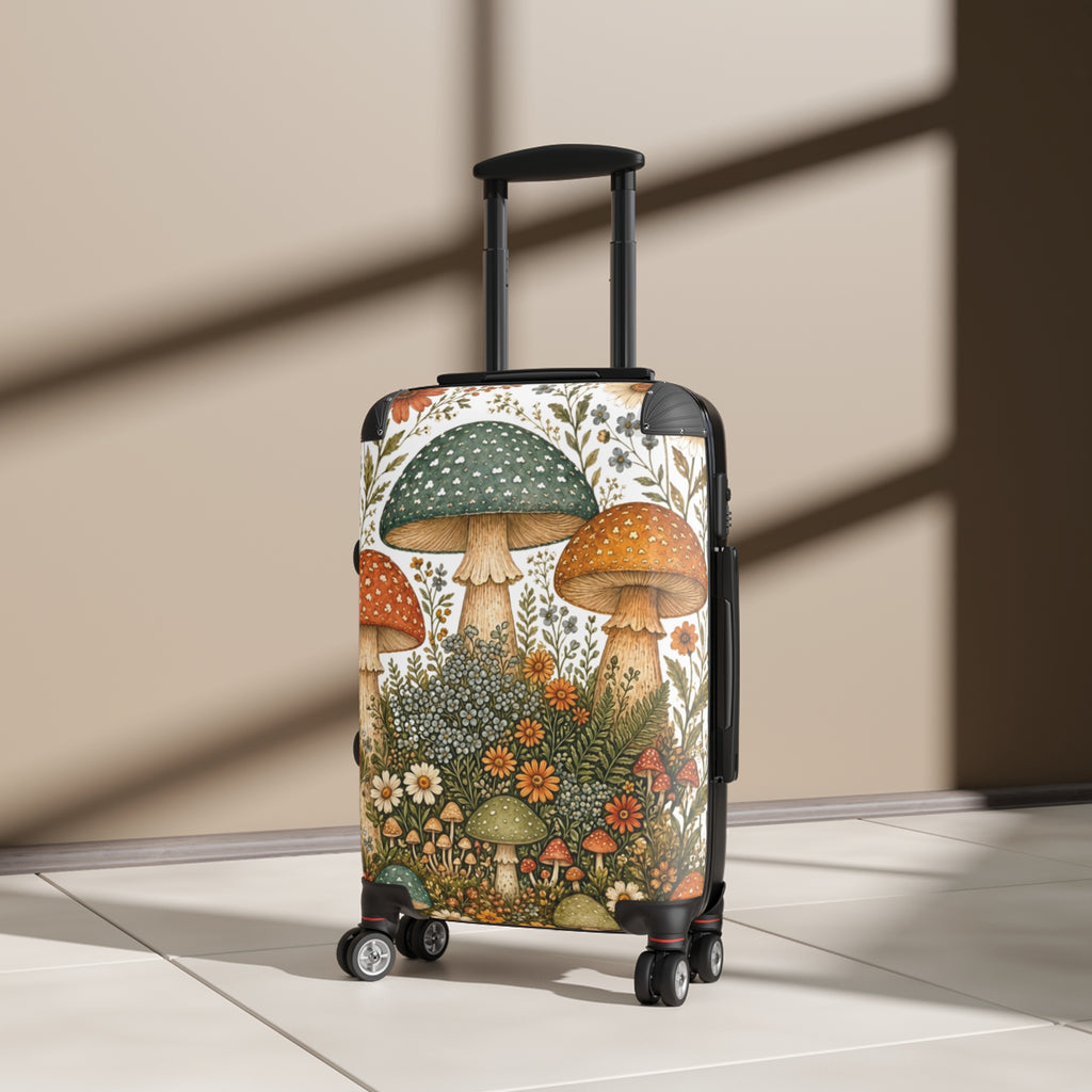 A hard-shell rolling suitcase with an illustrated mushroom and wildflower print, standing upright on a light floor against a beige wall with diagonal shadows.