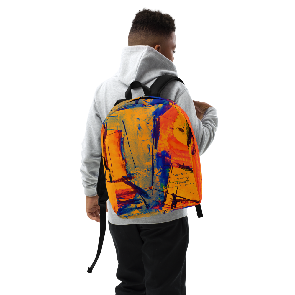 A person wearing a light gray hoodie and black pants, shown from the back while wearing a backpack with a vibrant abstract paint design in orange, yellow, blue, and red.